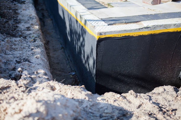 Professional Waterproofing technician working in Fenwick, MI